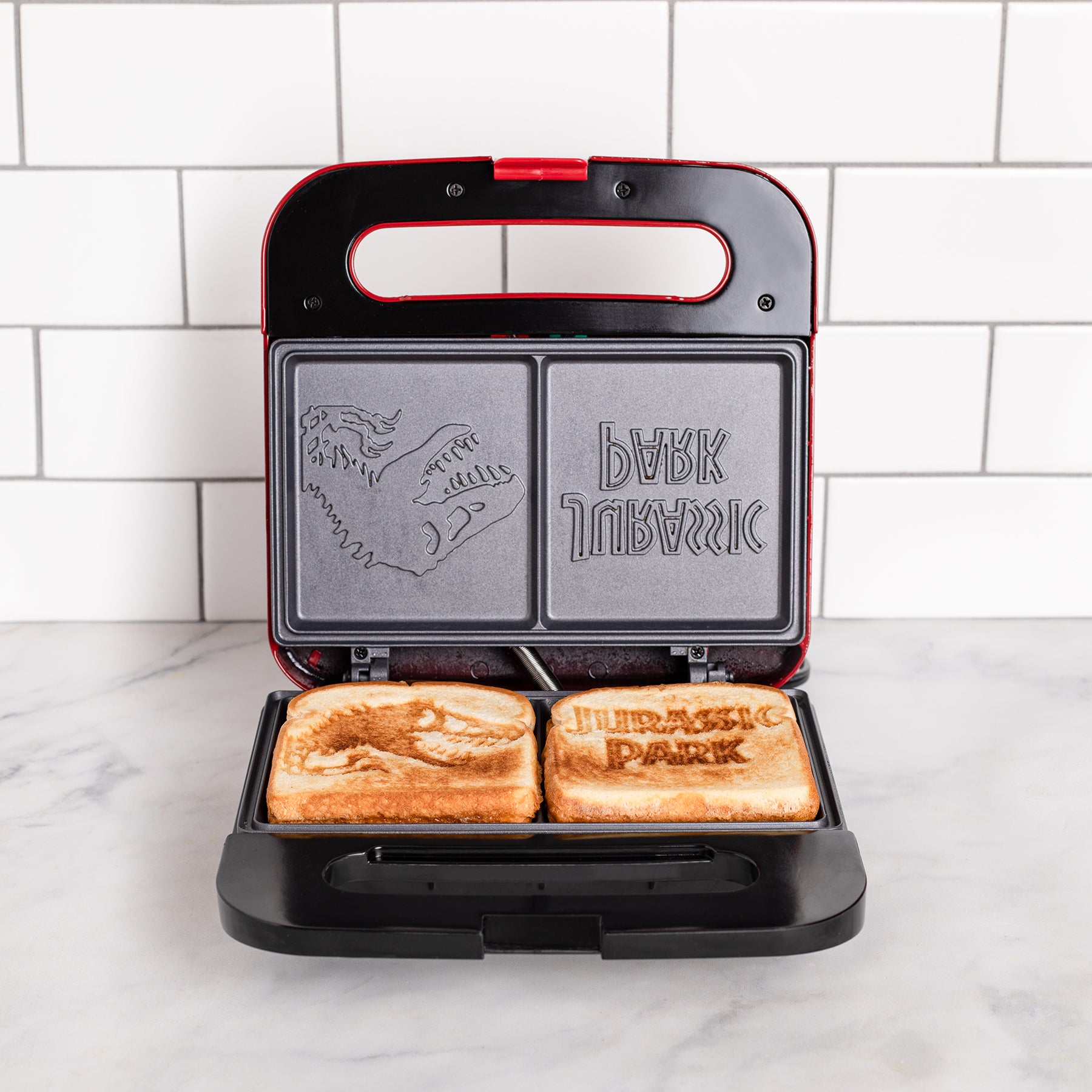 Uncanny Brands Jurassic Park Grilled Cheese Maker- Togo Uncanny Brands Jurassic Park Grilled Cheese Maker- Togo